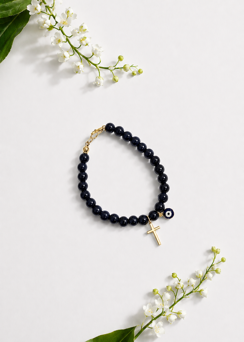 Black Mati Greek evil eye bracelet with a gold cross and black beads, handmade and made to order in Canada, symbolizing faith, strength, and protection.