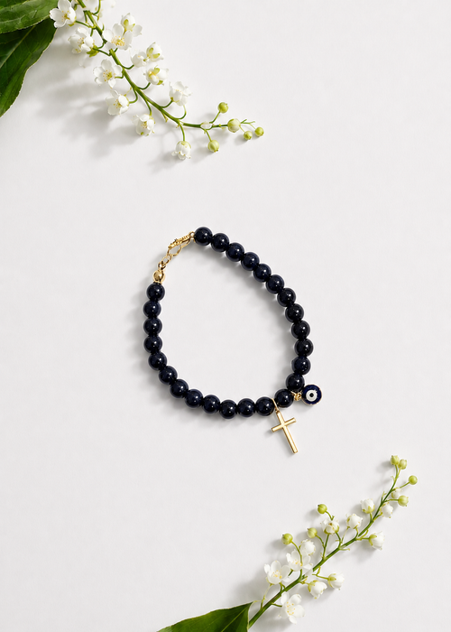 Black Mati Greek evil eye bracelet with a gold cross and black beads, handmade and made to order in Canada, symbolizing faith, strength, and protection.