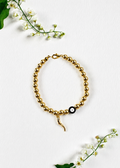 Handmade gold evil eye and Italian horn cornicello bracelet inspired by the traditional Italian symbol of protection from the malocchio, made to order in Canada.