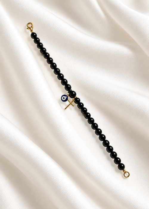 Black Mati Greek evil eye bracelet with a gold cross and black beads, handmade and made to order in Canada, symbolizing faith, strength, and protection.